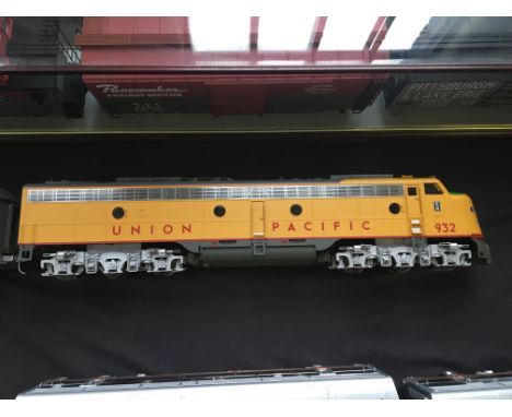 An Aristo-Craft Union Pacific 932 electric locomotive with Sherman Hill 1408 carriage.