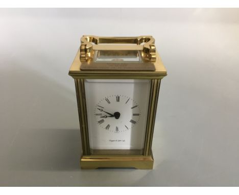 A Mappin and Webb brass cased carriage clock, and bevel glass panels.