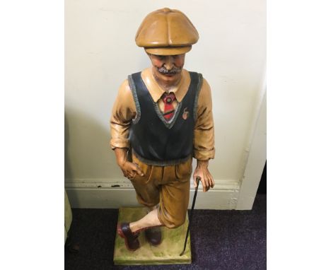 A resin figure of a vintage style golfer.