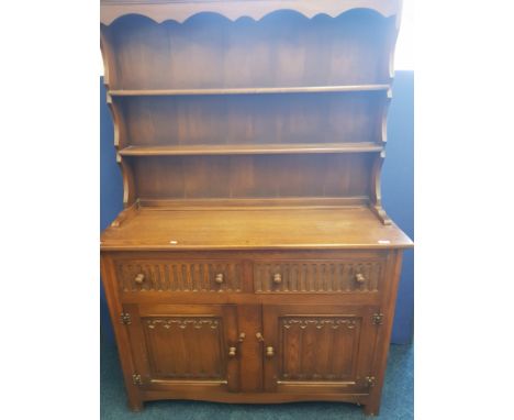 A reproduction oak Welsh dresser with shelf back