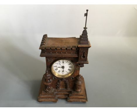 An oak castle torrit design mantle clock.