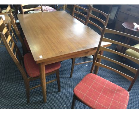 Made in Denmark teak extending dining table with stick ladder back chairs.