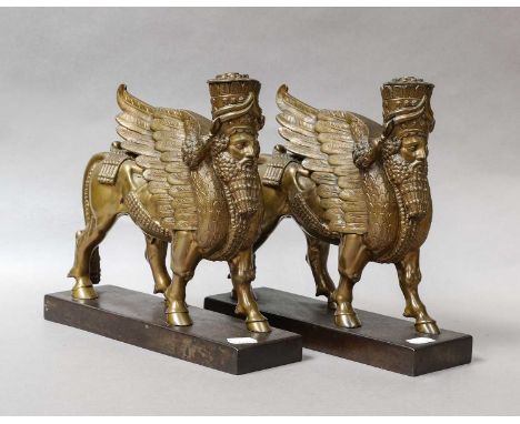 A pair of cast metal Assyrian style Lamassu winged bull bookends on plinth bases, 25cm by 26cm, together with a group of 20th