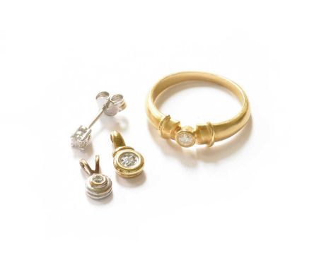 An 18 carat gold diamond solitaire ring, finger size Q; two diamond solitaire pendants; and a single diamond solitaire earrin