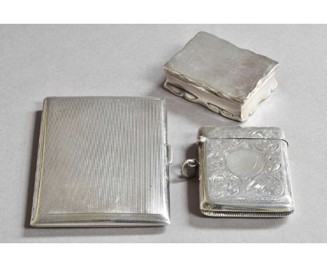 Three Various Silver Boxes, comprising: a shaped oblong snuff-box, Chester, 1894, 5cm wide; a vesta-case, engraved with folia