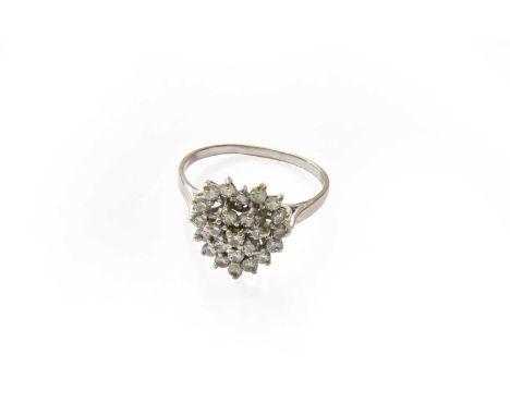 An 18 carat white gold diamond heart-shaped cluster ring, finger size RThe ring is in fair condition, the shank is misshapen.