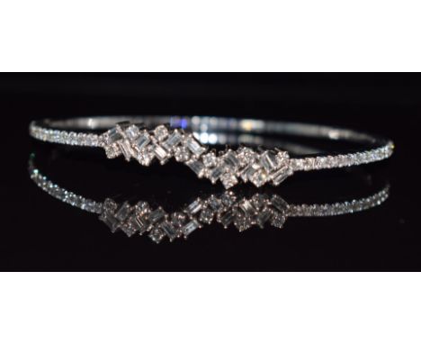 An 18ct white gold bangle set with emerald cut and round cut diamonds, 15g, 5.7 x 4.8cm