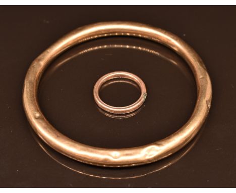 A 9ct rose gold flapper bangle and yellow metal ring, 10.9g