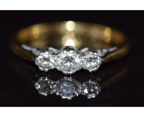 A 18ct gold ring set with three diamonds in a platinum setting, 2.4g, size K&nbsp;