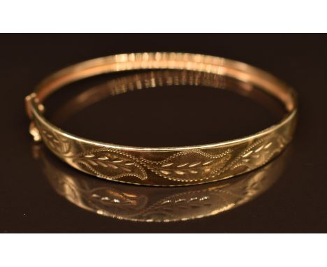 A 9ct gold bangle with foliate decoration, 6.5g, 6 x 5.5cm