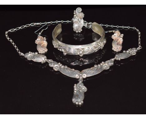 A suite of silver Navajo jewellery comprising bangle, necklace, ring and earrings