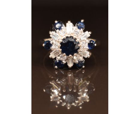 An 18ct white gold ring set with sapphires, round cut and baguette cut diamonds, 5.2g, size K