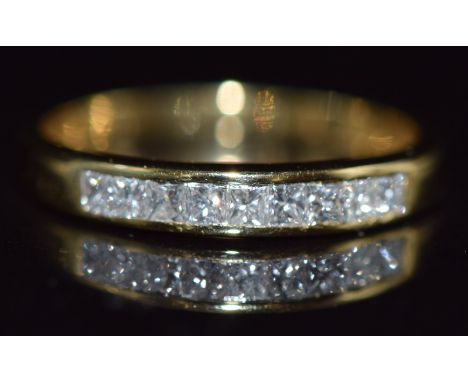 An 18k gold half eternity ring set with nine princess cut diamonds totalling approximately 0.6ct,1.8g, size K