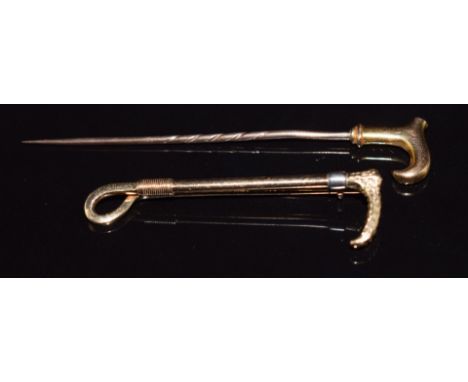 A 9ct gold and platinum brooch in the form of a riding crop (2.9g) and a 9ct gold stick pin in the form of a walking stick