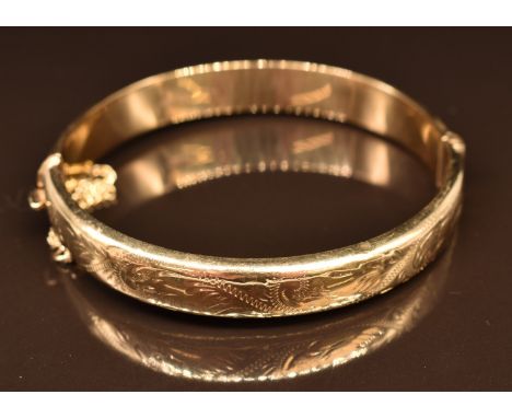 A 9ct gold bangle with engraved decoration, 13.3g, 6 x 5.5cm