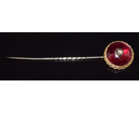 Victorian yellow metal stick pin set with a garnet cabochon and a rose cut diamond, 4.4g, 7cm long
