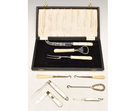 Hallmarked silver mother of pearl handled folding fork, fruit knife and button hook together with a case containing further b
