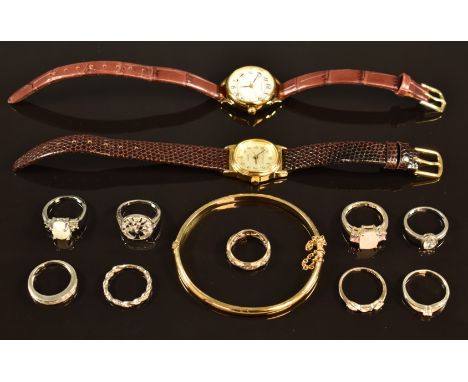 Nine silver rings, watches and rolled gold bangle