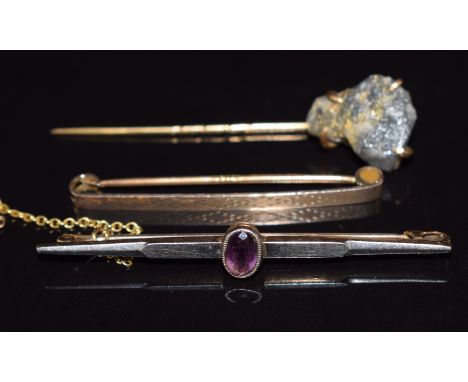 A 15ct gold and platinum brooch set with amethyst (3.7g), 9ct gold brooch (1.5g) and yellow metal stick pin set with gold ore