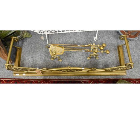 An Early 20th century Pierced Brass Fender, 134cm by 36cm by 37cm, internal 30.5cm by 122cm, together with a set of fire tool