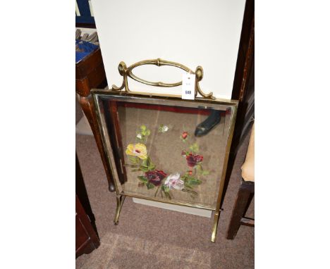 A Victorian framed mirror firescreen with bevelled edge and floral decoration.