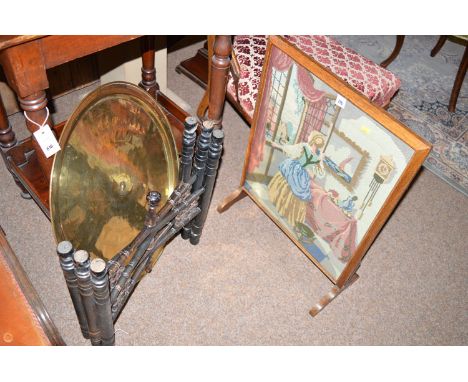 A circular benares brass tray and folding stand; and a woolwork firescreen.