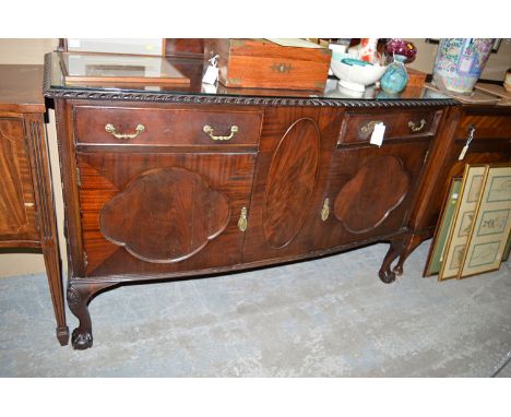 An early 20th Century mahogany bowfront sideboard, with short decorative back panel and moulded edge, the front fitted two sh