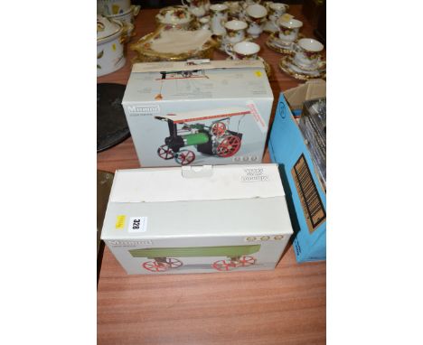 A Mamod live steam model of a steam tractor, in original box; together with a matching open wagon, also in its original box.