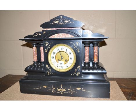 A Victorian slate and rose marble cased mantel clock, the arched pediment above arabic dial flanked by turned pillars, on pli