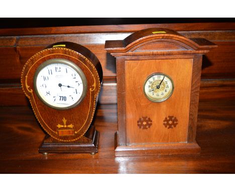 An eight day mantel clock in inlaid mahogany case; and another clock in mahogany case.