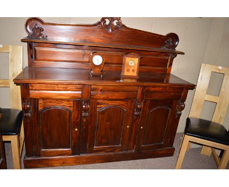 A reproduction mahogany sideboard, the back with floral scrolls over moulded shelf, the base fitted three frieze drawers abov