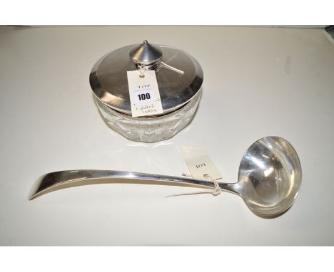 A silver mounted powder pot, the cut glass base with mirror set and engine turned silver cover; together with a plated ladle.