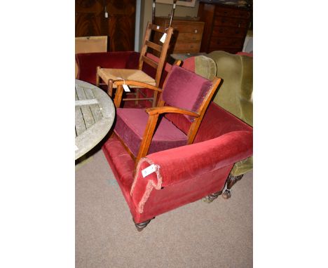 A 19th Century stuff-over settee with scrolling ends, upholstered in burgundy coloured velour, raised on turned legs terminat