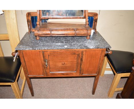 An early 20th Century oak washstand, the back panel set blue tiles above marble top, a single cupboard drawer under flanked b