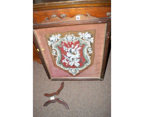 A Victorian beadwork panel of shield form decorated with flowers, in mahogany frame.