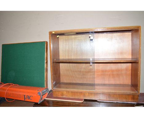 A bookcase with glass sliding doors; and a card table with folding legs.