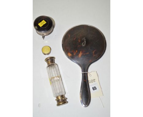 A silver mounted tortoiseshell hand mirror; a doubled ended scent bottle with white metal enamel terminals; a silver and tort
