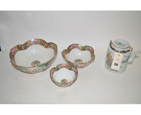 A Chinese teapot; and three graduated bowls.