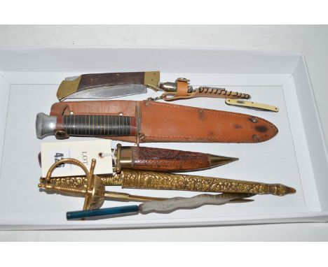 A modern Oriental style dagger with curved blade, in a brass and carved wooden scabbard with carved wooden handle with brass 