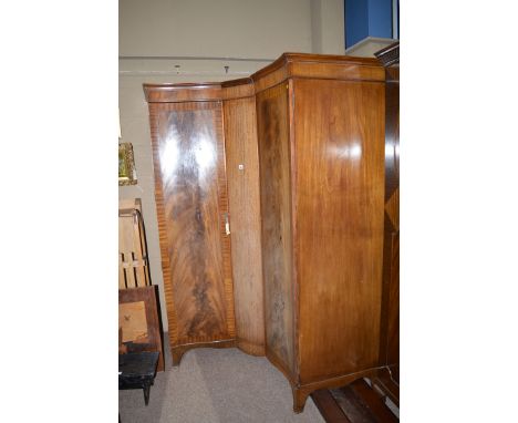 A mahogany corner wardrobe raised on bracket feet.
