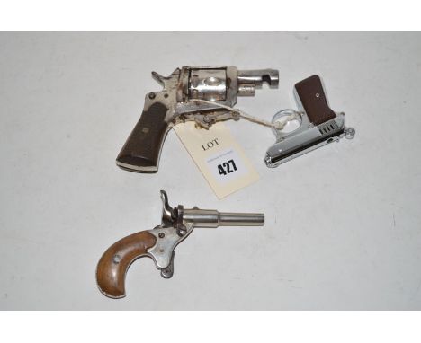 Two early 20th Century starting pistols; and a cigarette lighter in the form of a pistol.