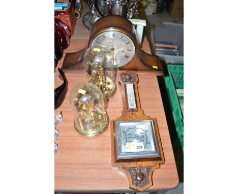 Two 400 day clocks with plastic domes; two mantel clocks; and a barometer in carved oak mount.