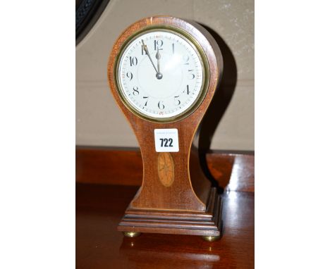 An Edwardian inlaid mahogany mantel clock, the arabic dial above inlaid paterae, on stepped base and brass feet.