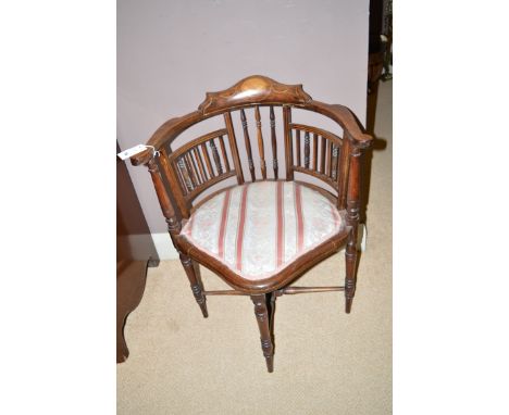 An Edwardian inlaid walnut corner chair, the shaped cresting rail inlaid with floral panel flanked by scrolling arms, raised 