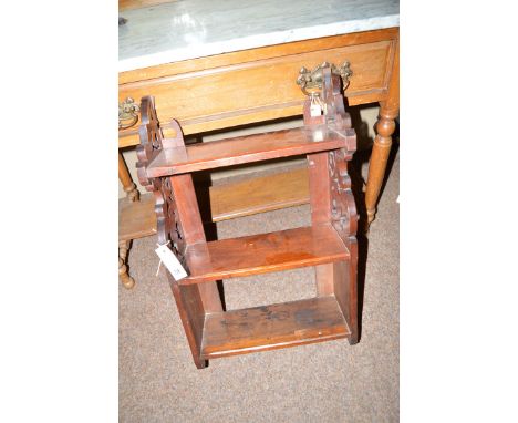 An early 20th Century mahogany hanging shelf unit, the three shelves decorated with pierced scrolling sides.