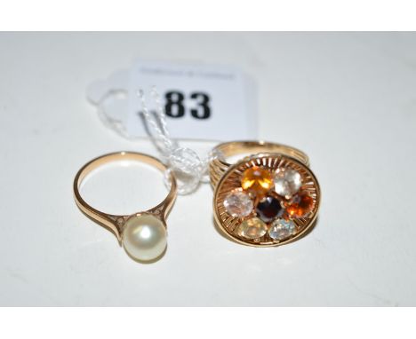 A gem set ring of orange, red and white and blue stones on openwork shank and mount, ring size M; together with a cultured pe