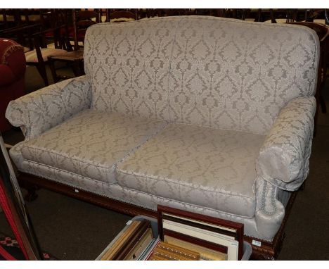 An Edwardian style two-seater sofa on claw and ball feet, upholstered in light grey damask fabric 