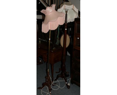 A mahogany inlaid standard lamp with claw and ball feet and a brass standard lamp with a carved wooden base (2)