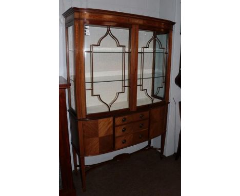 An Edwardian inlaid walnut display cabinet.  125cm wide by 37cm deep by 185cm high. Uniform fading, central marquetry panel t