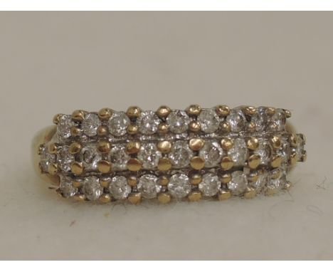 A ladies dress ring having three rows of diamonds on a 9ct gold loop